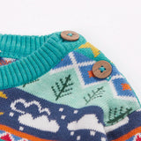 Close up of the wooden buttons on the shoulder of the Frugi festive fair isle organic cotton jumper.