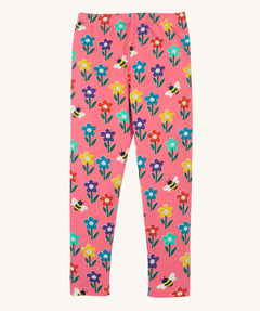Frugi organic cotton kids Libby leggings with a fun flowers print on a pink background.