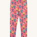 Frugi organic cotton kids Libby leggings with a fun flowers print on a pink background.