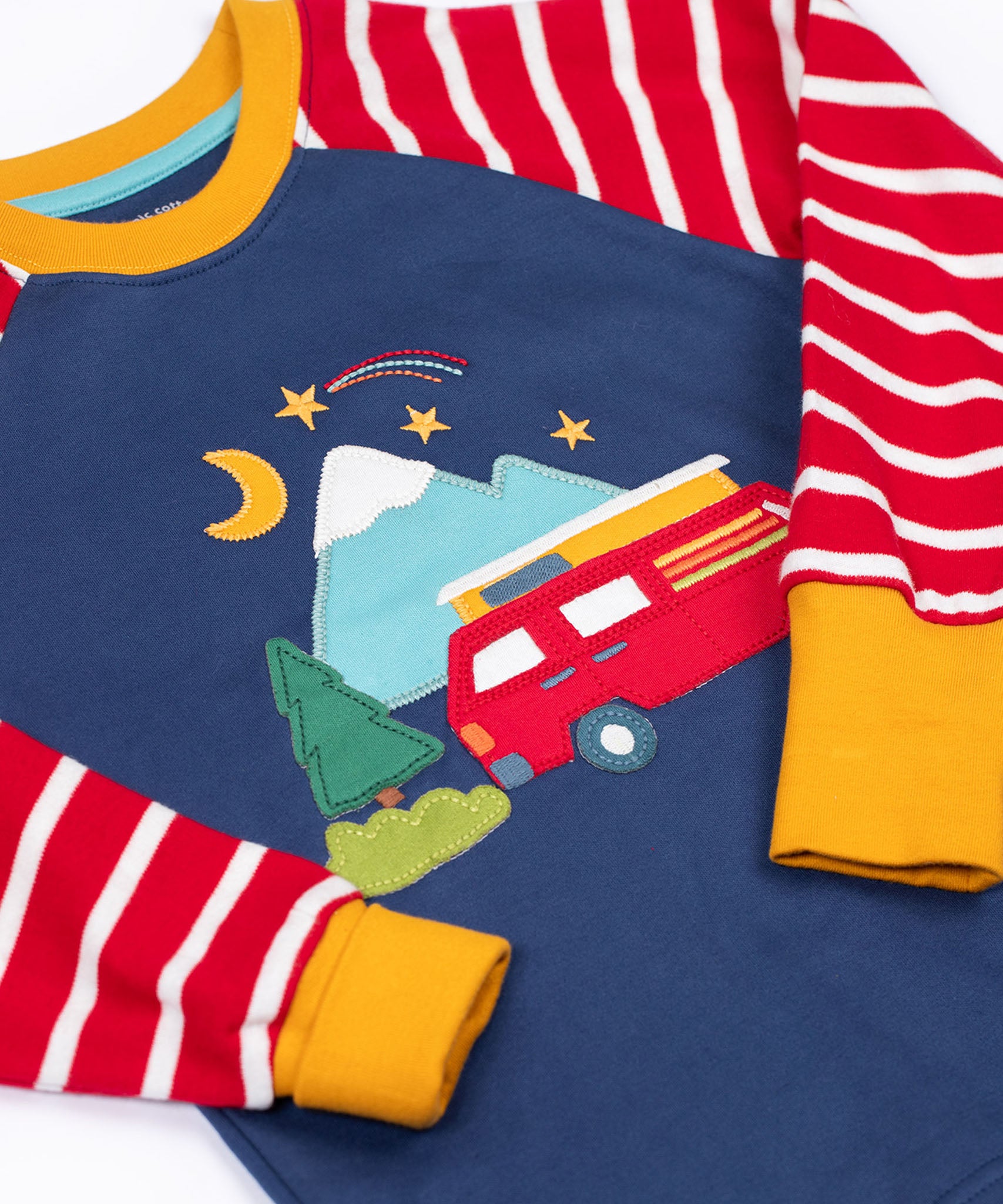 A close up of the campervan applique detail on the front of the Frugi breton campervan design organic cotton jamie jim jams long sleeved pyjamas.