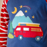 A close up of the campervan applique detail on the front of the Frugi jamie jim jams, being worn by a child.