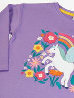 Close up Frugi organic cotton bethany long sleeved periwinkle purple top with a pegasus applique with a rainbow and flowers. 