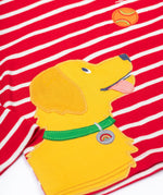 A close up of the yellow dog applique on the front of the Frugi Discovery Organic Cotton Circular Kids' Top with a red and white Breton Stripe.