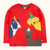 Frugi organic cotton adventure circular long sleeve top scarlet red with three dogs wearing party hats appliques on the front. 