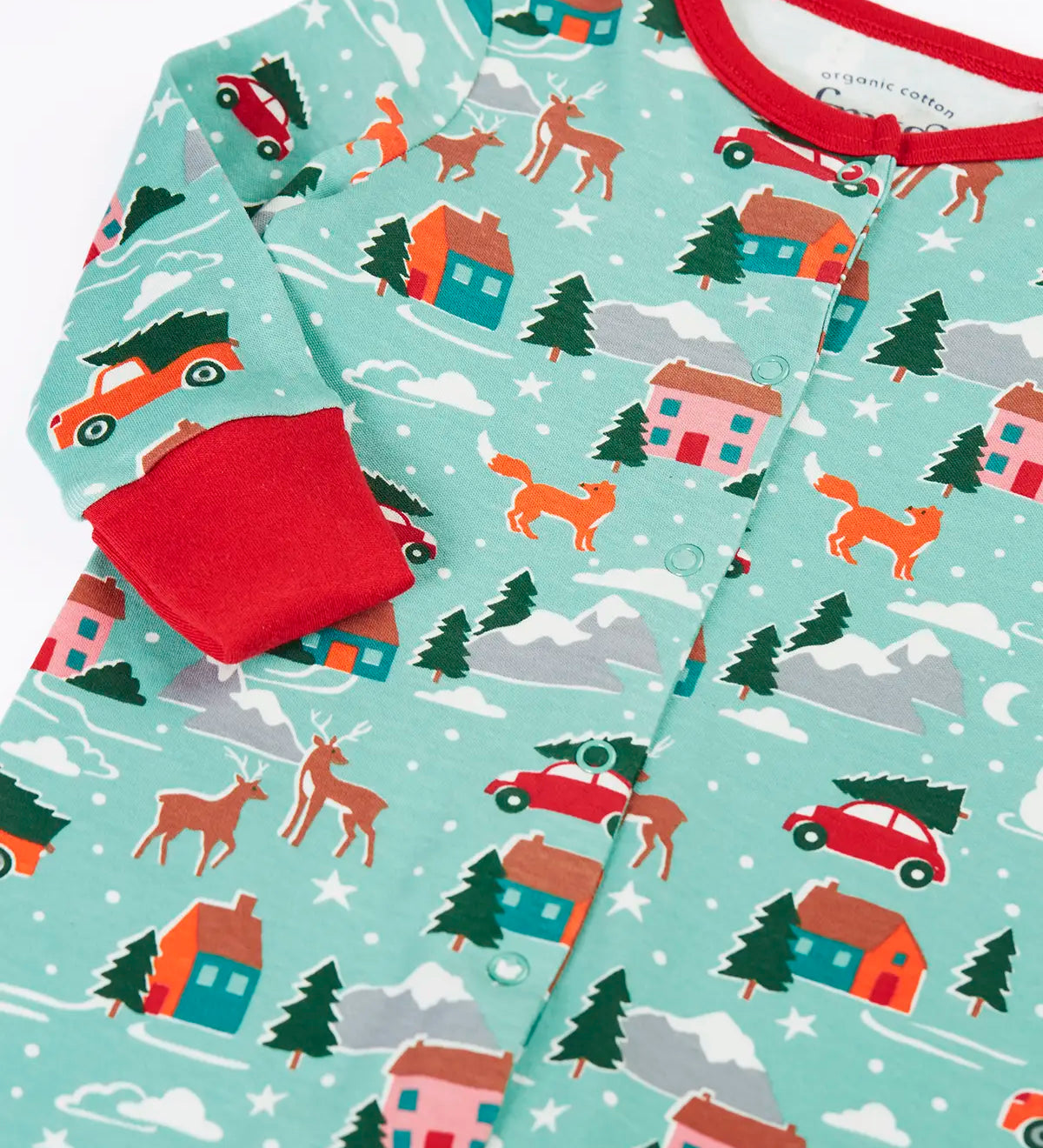 Close up of the fold over cuffs on the Frugi organic cotton lovely babygrow with a winter drives print.