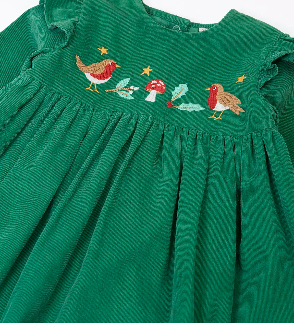 Close up of the robin, mistltoe, holly and toadstool festive details on the front of the Frugi organic cotton maud holly green corduroy dress.