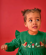 Close up of the embroidery on the front of the Frugi organic cotton maud holly green corduroy dress being worn by a child.