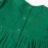 Close up of the popper closure on the back of the Frugi organic cotton maud holly green corduroy dress.