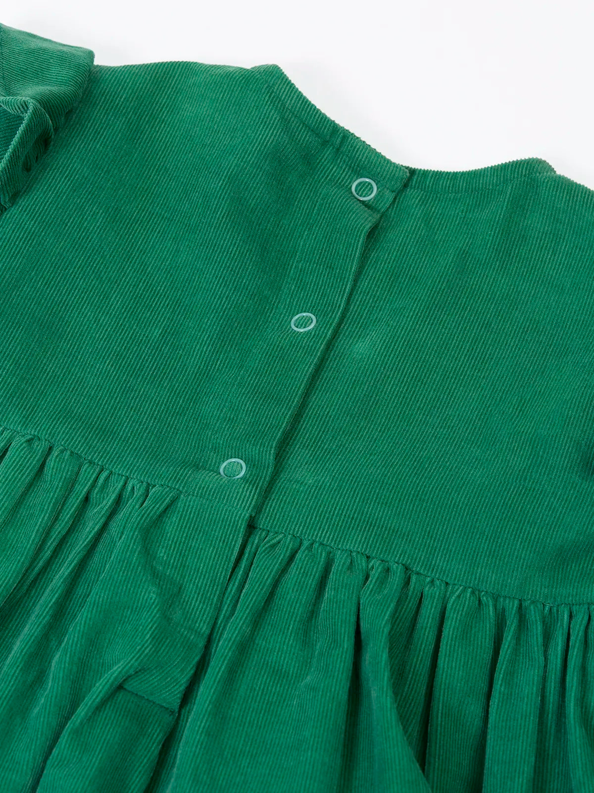 Close up of the popper closure on the back of the Frugi organic cotton maud holly green corduroy dress.