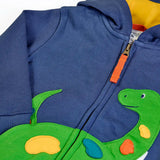 Close up of the green nessie applique on the front of the Frugi organic cotton carbis navy kids hoodie. The zip has an orange pull tab.