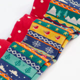 Close up of the Frugi organic cotton norah tights 2 pack. One scarlet red with spots on the lower half and stripes on the top. One Fair Isle pair with festive details.