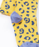 A close up of the primrose prurple colour block heel caps on the knees of the Frugi Organic Cotton Norah Leopard Knitted Tights. These tights are part of a wide range of organic cotton clothing for children available here at Babipur. 