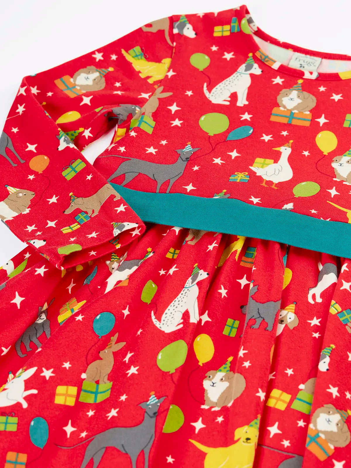 Close up of the front of the Back of the Frugi organic cotton pink party skater dress in a pet paw-ty print with a teal waist band.