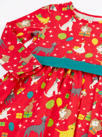 Close up of the front of the Back of the Frugi organic cotton pink party skater dress in a pet paw-ty print with a teal waist band.