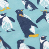 A close up view of the print Frugi long sleeved organic cotton sundown pyjamas with a penguin waddle print.