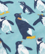 A close up view of the print Frugi long sleeved organic cotton sundown pyjamas with a penguin waddle print.