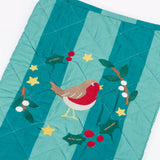 Close up of the Frugi organic cotton christmas stocking. Striped teal quilted style stocking with a robin wreath applique detail and hanging loop.