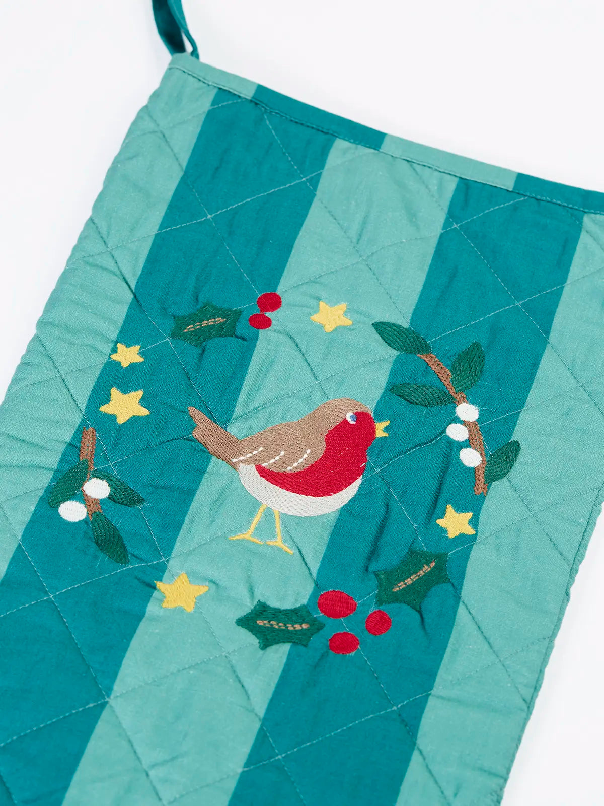 Close up of the Frugi organic cotton christmas stocking. Striped teal quilted style stocking with a robin wreath applique detail and hanging loop.