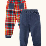 Frugi organic cotton ronnie reversible pull up trousers, festive check on one side and navy corduroy on the other. 