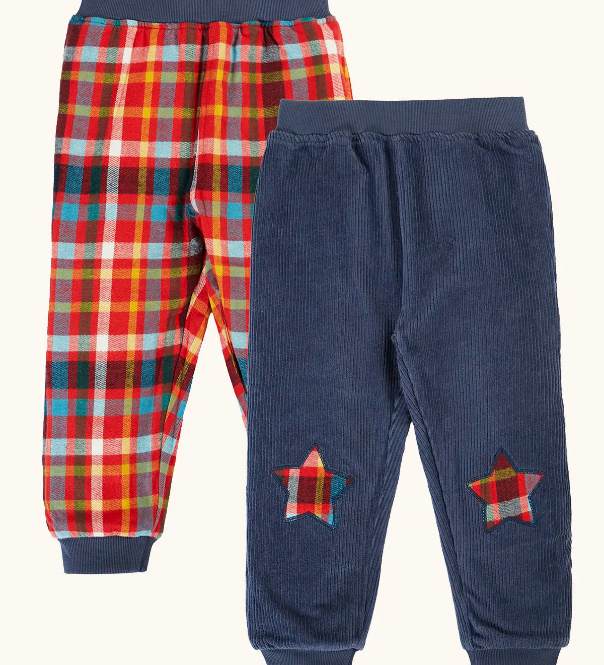 Frugi organic cotton ronnie reversible pull up trousers, festive check on one side and navy cord with festive check star knee patches on the other.