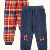 Frugi organic cotton ronnie reversible pull up trousers, festive check on one side and navy cord with festive check star knee patches on the other.