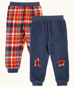 Frugi organic cotton ronnie reversible pull up trousers, festive check on one side and navy cord with festive check star knee patches on the other.