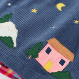Close up of the pink house applique on the Frugi organic cotton rosalie reversible dress hemline.