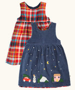 Frugi organic cotton rosalie reversible dress, one side in navy corduroy with appliques on the hemline and snow and stars on the skirt. One side in festive multicoloured check