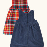 Back of the Frugi organic cotton rosalie reversible dress, one side in navy corduroy, one side in festive multicoloured check  popper closures down the middle.
