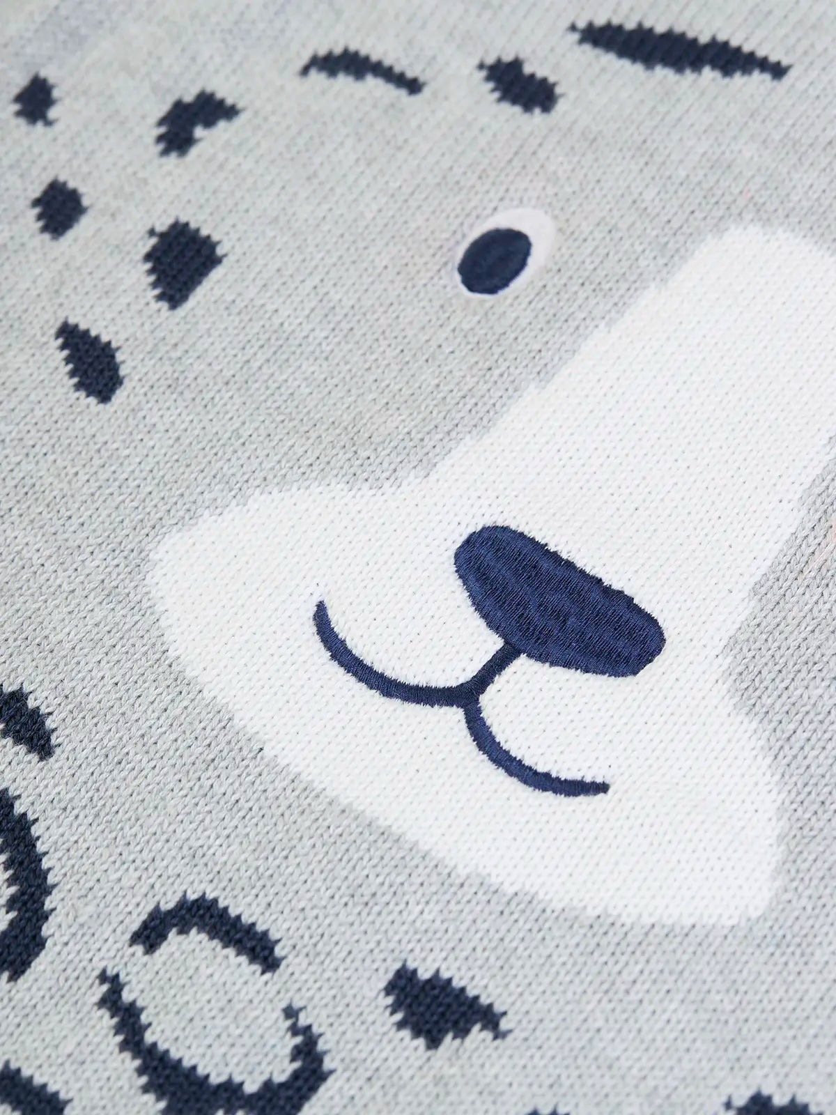 Close up of the details on the snow leopards face on the Frugi organic cotton character knit jumper with 3d ears, green neck trim and rainbow arm cuffs and hemline. 