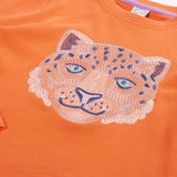 Close up of the Frugi snow leopard organic cotton salamander orange long sleeve top.