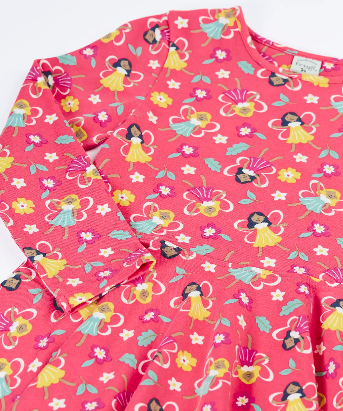 Close up of the Frugi GOTS organic cotton long sleeved sofia skater dress in fairy flutter. Pink background with colourful fairy print featuring flowers and leaves.
