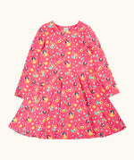 Frugi GOTS organic cotton sofia skater dress in fairy flutter. Pink background with colourful fairy print featuring flowers and leaves.