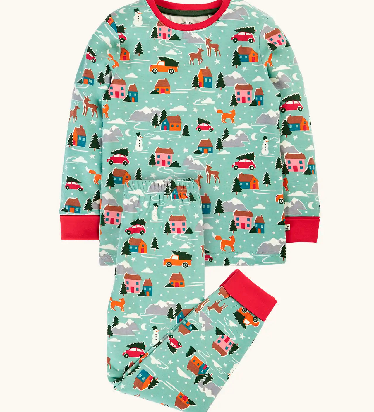 Frugi organic cotton sundown kids long sleeve pyjama set with a winter drives print. Light green long sleeved pyjama top and matching trousers featuring an all over repeat print with houses, reindeer, snow topped mountains, fox and stars. 