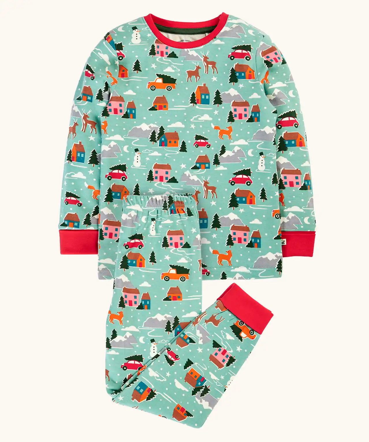 Frugi organic cotton sundown kids long sleeve pyjama set with a winter drives print. Light green long sleeved pyjama top and matching trousers featuring an all over repeat print with houses, reindeer, snow topped mountains, fox and stars. 