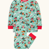 Frugi organic cotton sundown kids long sleeve pyjama set with a winter drives print. Light green long sleeved pyjama top and matching trousers featuring an all over repeat print with houses, reindeer, snow topped mountains, fox and stars. 