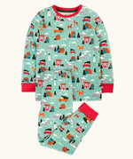 Frugi organic cotton sundown kids long sleeve pyjama set with a winter drives print. Light green long sleeved pyjama top and matching trousers featuring an all over repeat print with houses, reindeer, snow topped mountains, fox and stars. 