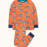 Frugi organic cotton sundown kids long sleeve pyjama set with a leopard leap print. Orange long sleeved pyjama top and matching trousers featuring an all over repeat print of grey leopards with navy cuffs and neck trim.