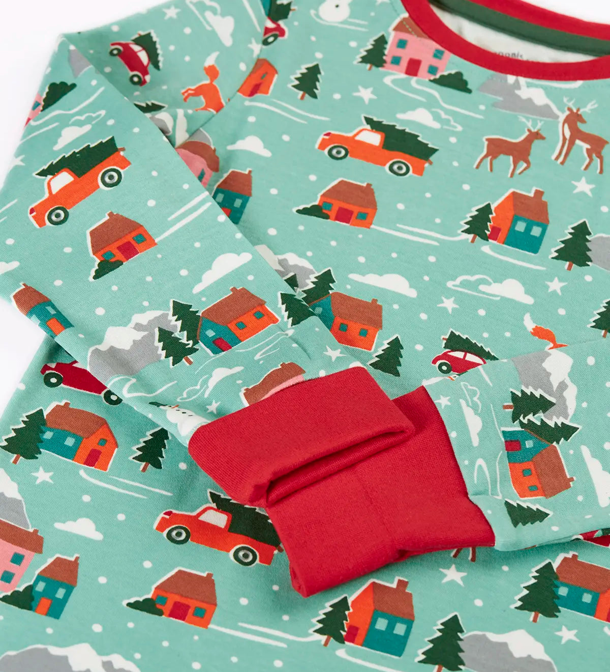 Close up of the red extendable fold over cuffs on the Frugi organic cotton sundown kids long sleeve pyjama set with a winter drives print.