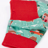 Close up of the red contrast extendable cuffs on the Frugi organic cotton sundown long sleeved pyjamas in winter drives print. 