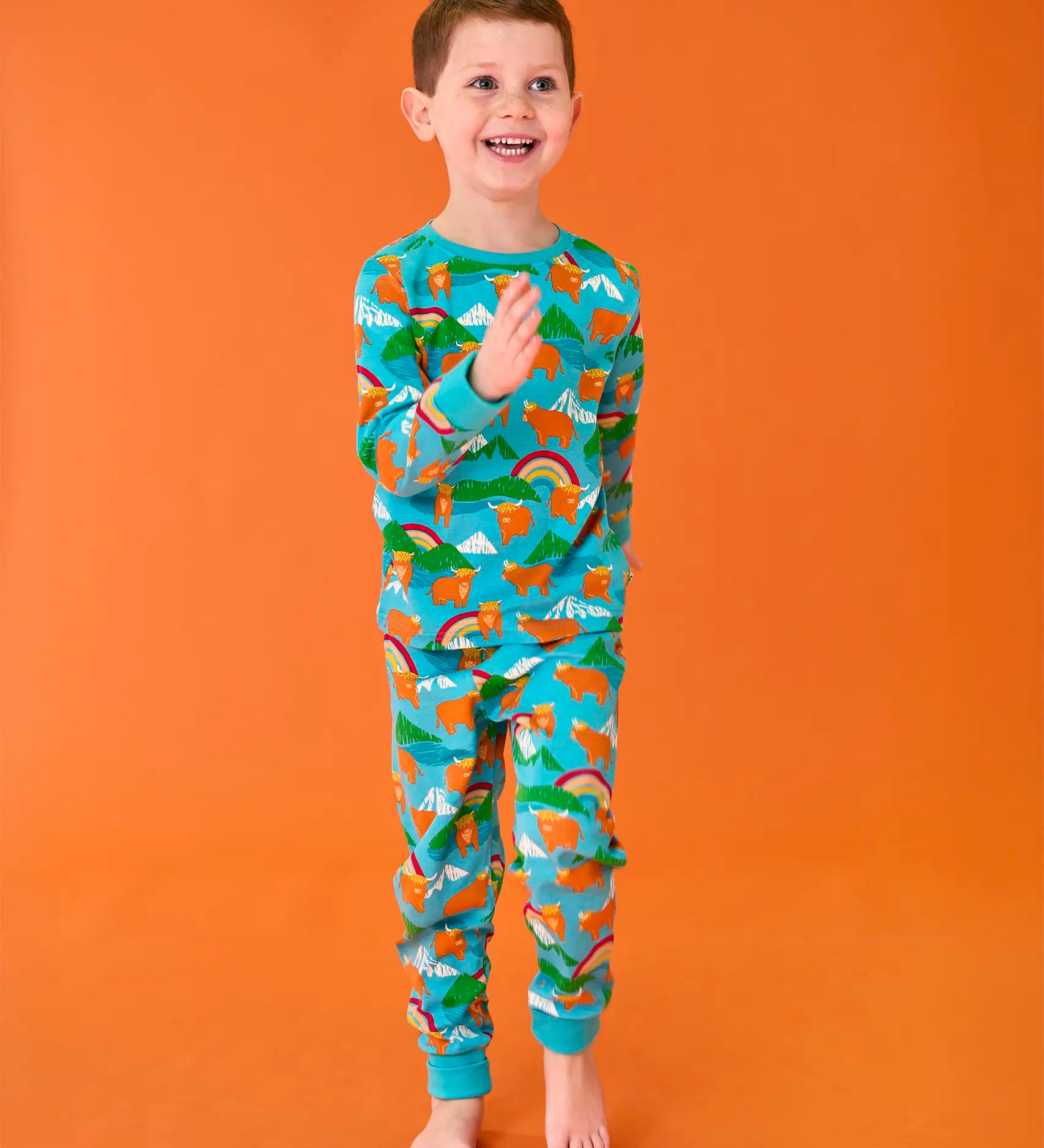 Frugi organic cotton sundown turquoise pyjamas with a Highland Coos cows print.