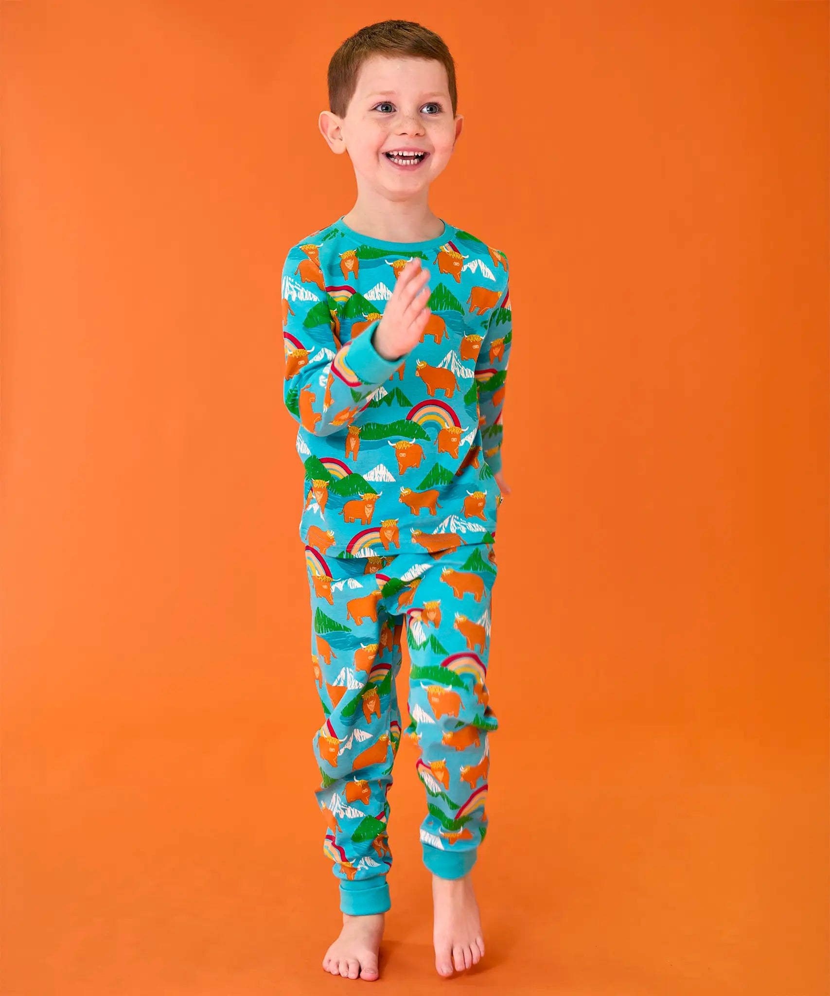 Frugi organic cotton sundown turquoise pyjamas with a Highland Coos cows print.