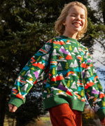 Child wearing the Frugi GOTS organic cotton superb sweatshirt with rescue trails print with rust orange corduroy trousers.