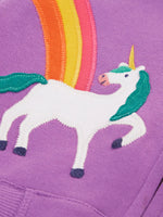 Close up of the unicorn and rainbow appliques on the front of the Frugi organic cotton purple periwinkle carbis zipped children's hoodie. 