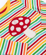 A close up of the red mushroom applique on the front of the Frugi orion long sleeved, rainbow coloured breton striped child's organic cotton top.