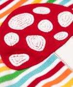 A super close up of the red mushroom applique on the front of the Frugi orion long sleeved, rainbow coloured breton striped child's organic cotton top.