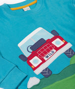 A close up of the red truck applique on the front of the Frugi Organic Cotton Owen Panel Circular Top in a Boat Blue colour with Truck design.