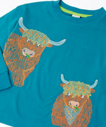 Close up of the details on the highland cow embroidery on the Frugi Owen long sleeve top in boat blue.