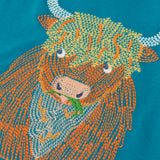 Close up of the details on the highland cow embroidery on the Frugi Owen long sleeve top in boat blue.