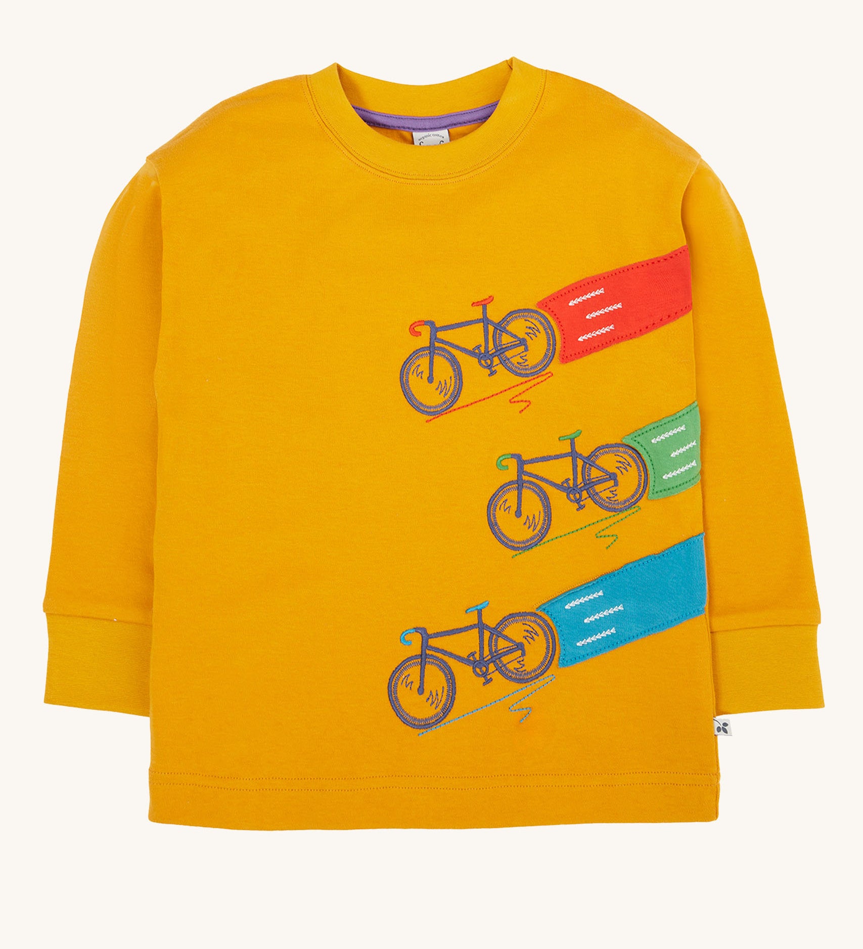 Frugi Owen top in a yellow gold colour featuring a bicycle design on the front. Three embroidered bicycles each with different coloured applique roads behind them.